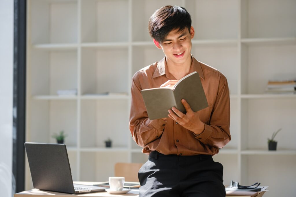 Young man studying online and researching financial concepts for education and career development